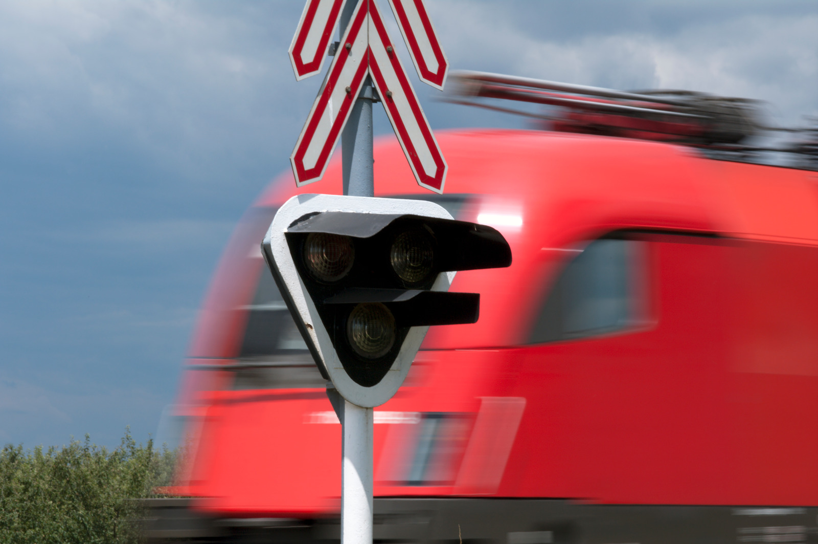 Red train and railway signal